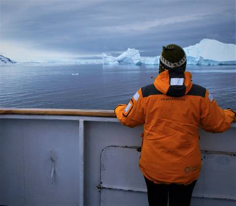 Image Title: Enjoying the icebergs in the Bellingshausen Sea in a new polar explorer parka. [Photo: Open Door Travelers]