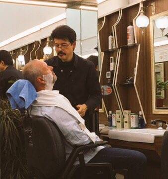 Image Title: Phil getting an Italian shave. [Photo: Open Door Travelers]