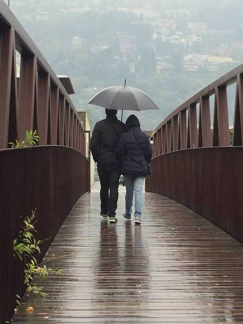 Image Title: A lover's walk in the rain in Lugano, Swtazerland. [Photo: Open Door Travelers]