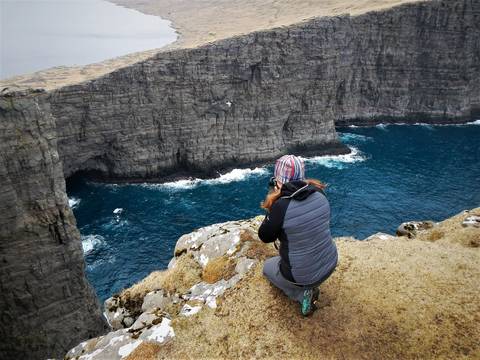 Image Title: Photographing sea cliffs in the Faroe Islands [Photo: Open Door Travelers]