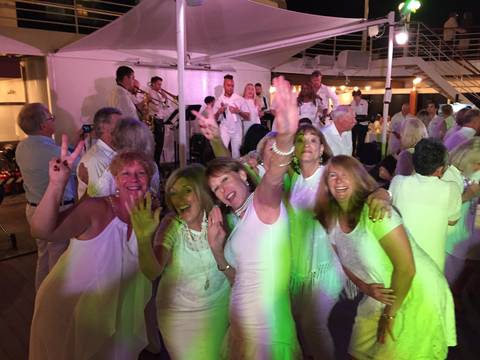 Image Title: Dancing Queens at the infamous Azamara White Night Party. [Photo: Open Door Travelers]