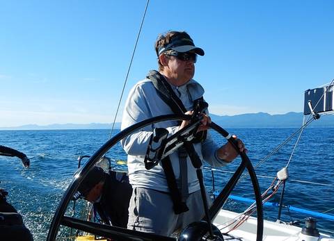 Image Title: Transpac 52 Sonic Owner/driver, Marek Omilian at the Helm. 
[Photo: Open Door Travelers]